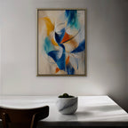 Cobalt and Saffron Swirl Canvas Art – vertical cobalt and orange abstract print in a gold floating frame in a dining room