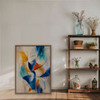 Cobalt and Saffron Swirl Canvas Art – vertical cobalt and orange abstract print in an oak floating frame styled on a shelf