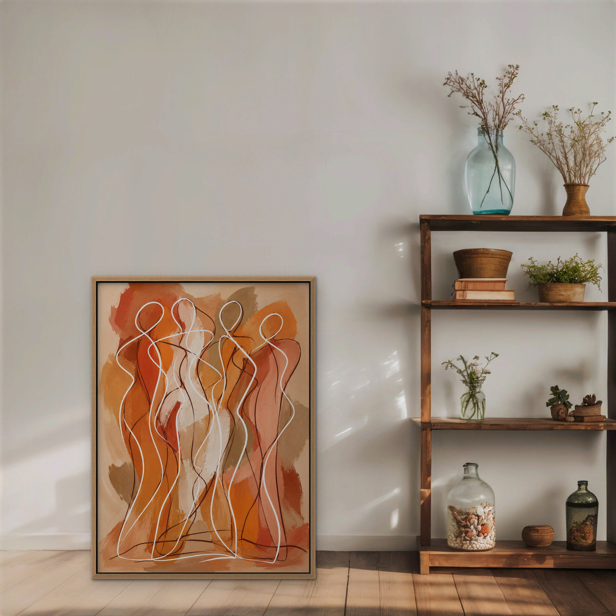Dancing Figures Canvas Art – vertical orange figurative line art print in an oak floating frame styled on a shelf