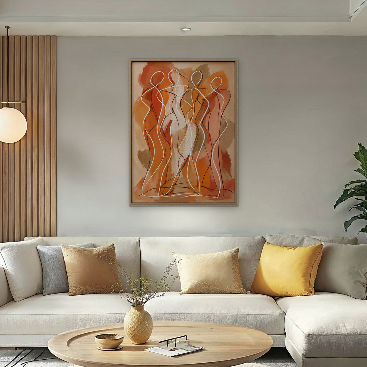 Dancing Figures Canvas Art – vertical orange figurative line art print in an oak floating frame in a bright living room