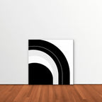 Monochrome Arc Canvas Art – square black and white geometric abstract print as a gallery-wrapped canvas leaning against a white wall
