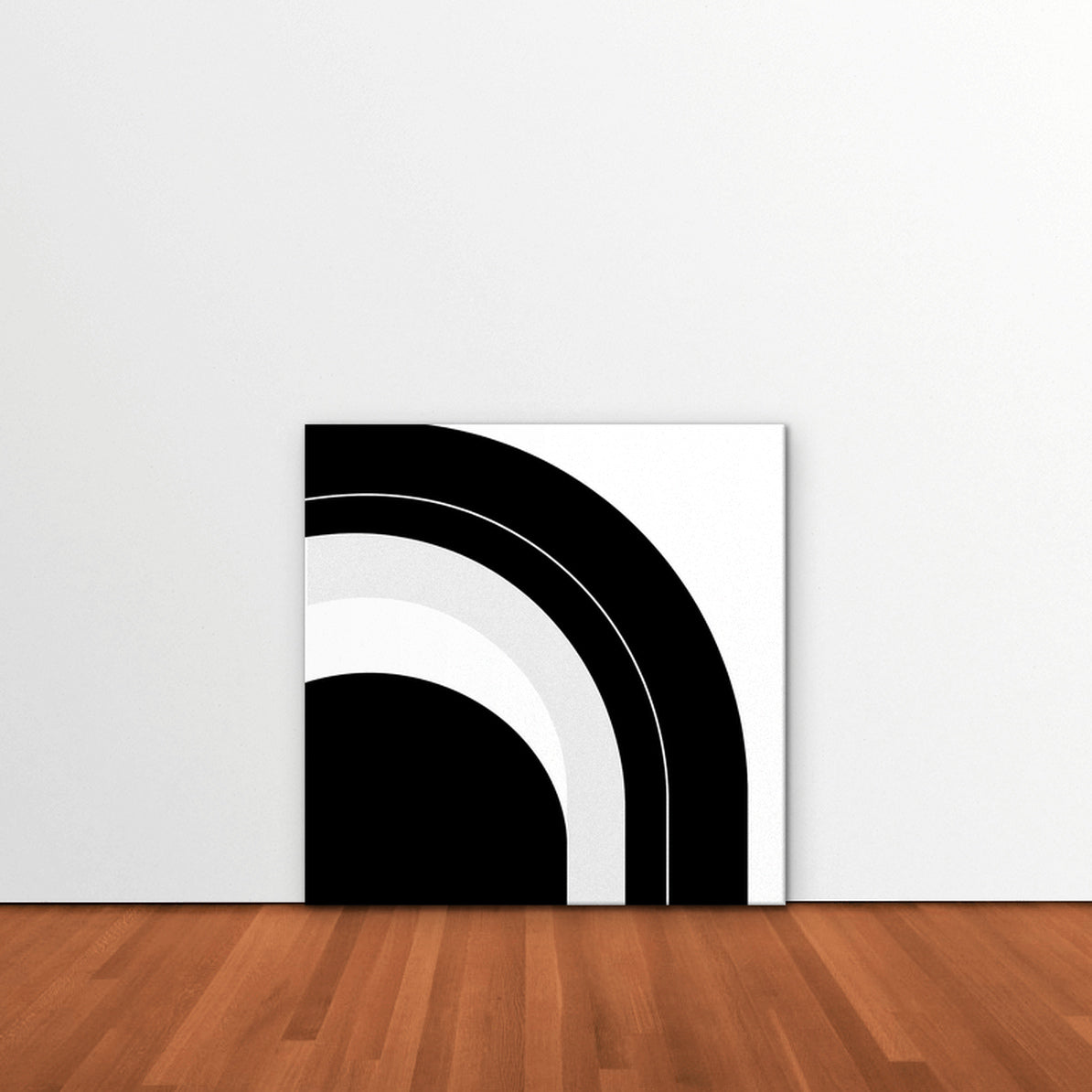 Monochrome Arc Canvas Art – square black and white geometric abstract print as a gallery-wrapped canvas leaning against a white wall