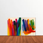 Rainbow Brushstrokes Canvas Art – set of 2 vertical multicolor brushstroke abstract prints as a gallery-wrapped canvas leaning against a white wall