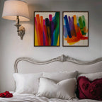 Rainbow Brushstrokes Canvas Art – set of 2 vertical multicolor brushstroke abstract prints in a walnut floating frame in a bedroom